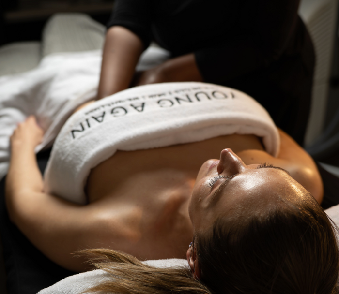 Aesthetician doing fascia massage on client.