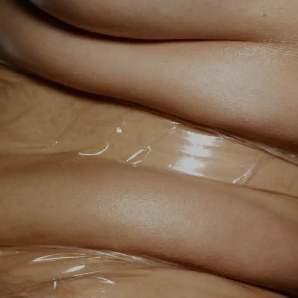 Glossy, smooth tan skin with translucent plastic wrap partially covering the surface.