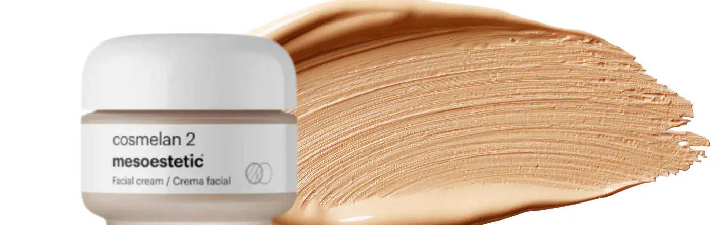 A sleek white jar of cosmelan 2 facial cream from mesoestetic, displayed beside a swatch of its smooth, light beige foundation-like texture.