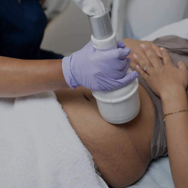 White cylindrical body with silver metallic top, used for non-invasive skin treatment