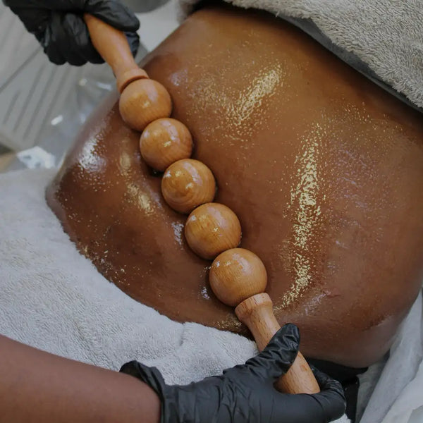 Wooden massage roller with smooth, rounded beads and a polished finish.